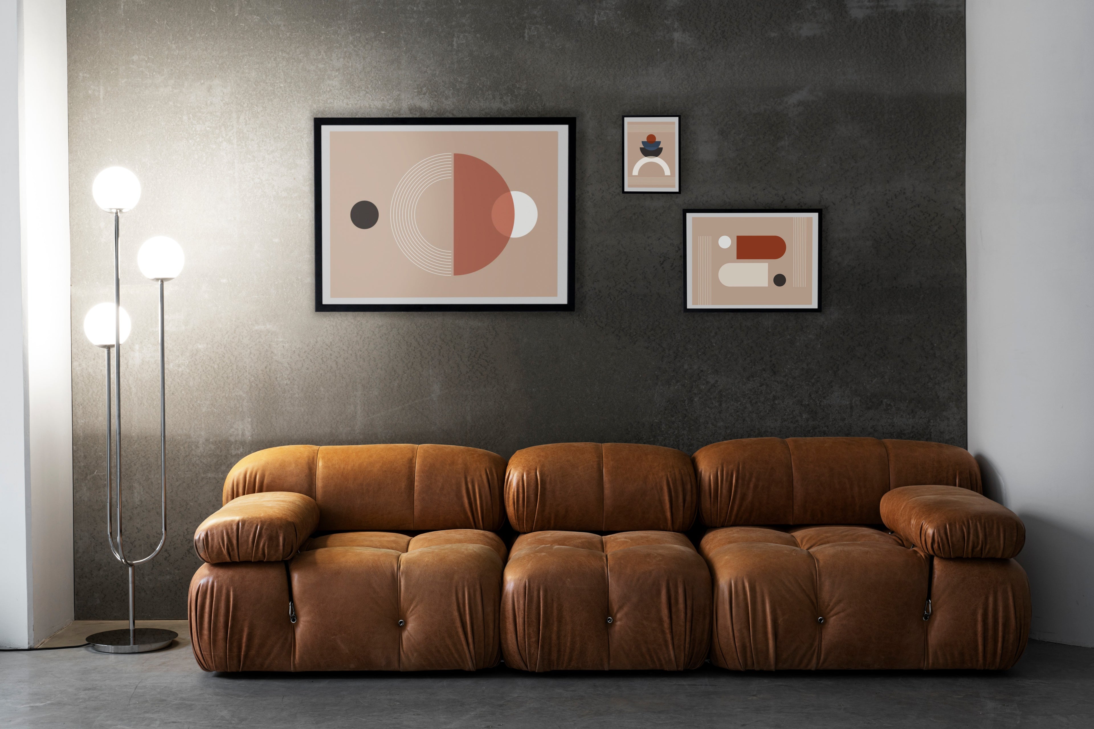 Interior design featuring a brown couch with photoframes on the wall